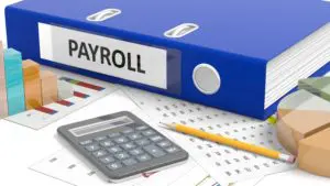 Blue binder and payroll equipment for Payroll Services with Jennifer Young's Bookkeeping in Rapid City, S.D.